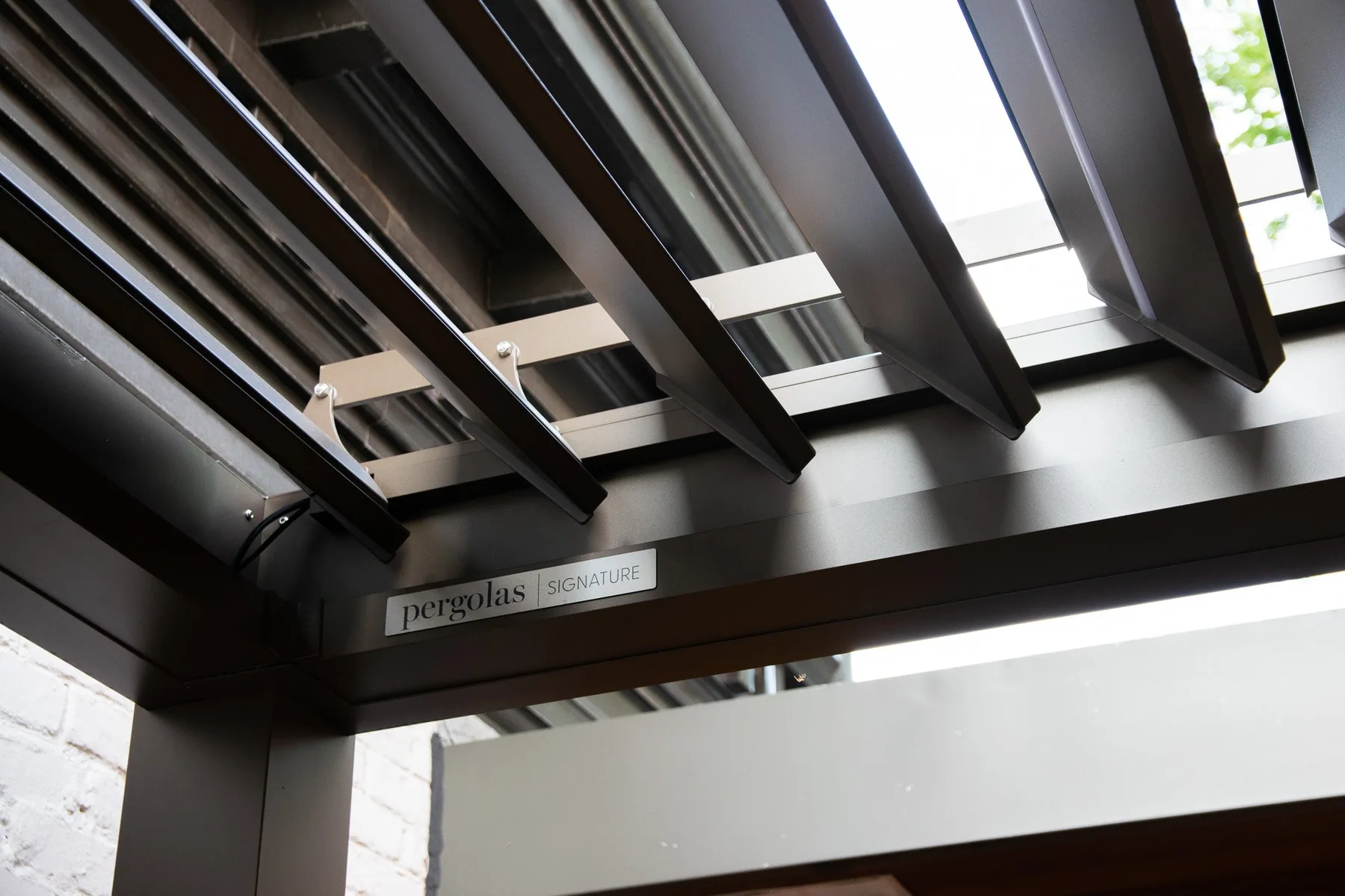 Pergola bioclimatique Provence en aluminium au-dessus d’une terrasse en bois