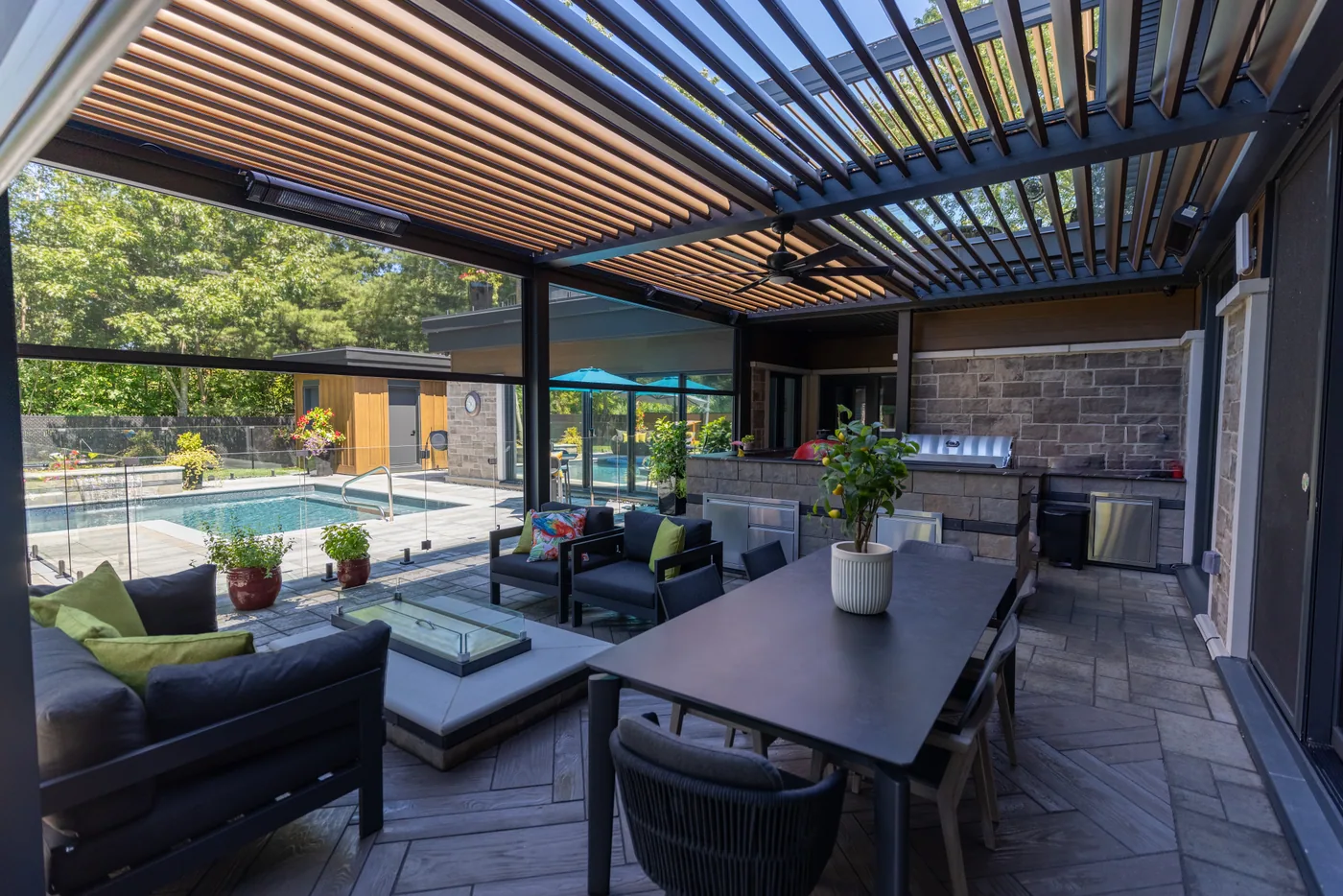 Ground-floor terrace under the Capri pergola, wood-tone louvres and ceiling fan