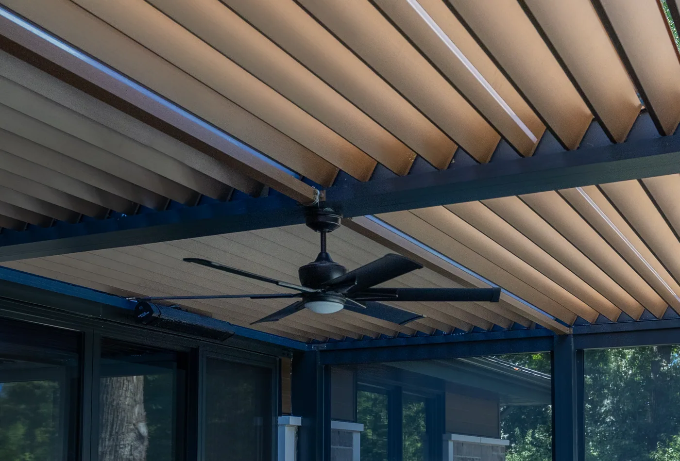 Fan bolted to the pergola beam, under the closed louvres