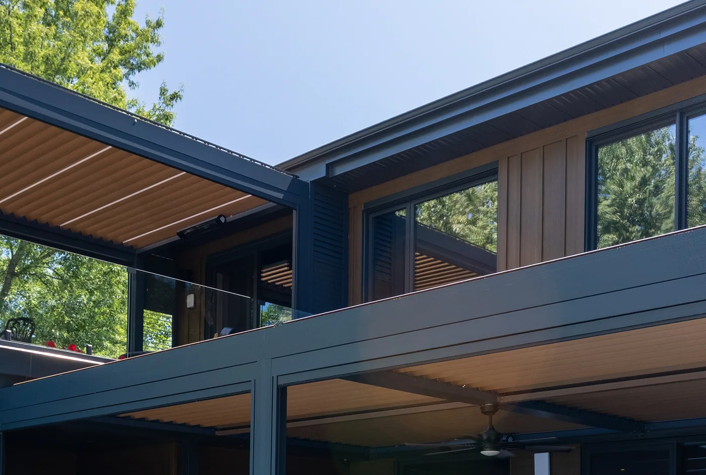 Pergola louvres and the home’s wood cladding, in the same colour