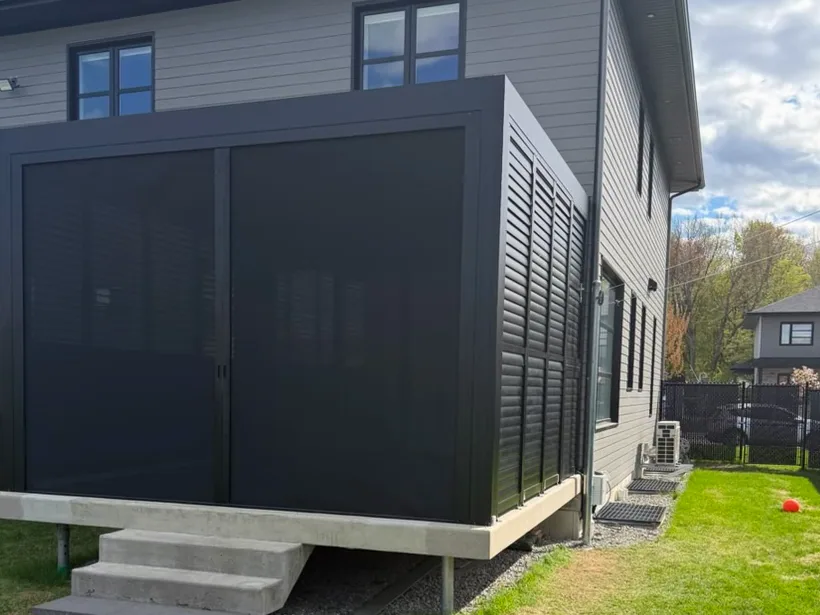 Horizontal solar shade drawn across the whole front of the pergola, louvred privacy wall at the end