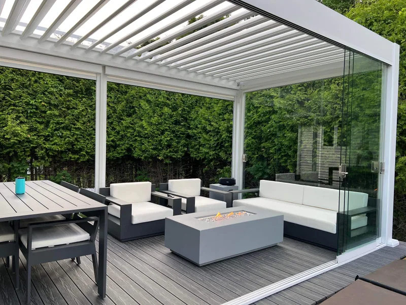Pergola bioclimatique Provence fermée de verre coulissant sur une terrasse neuve à Beaupré