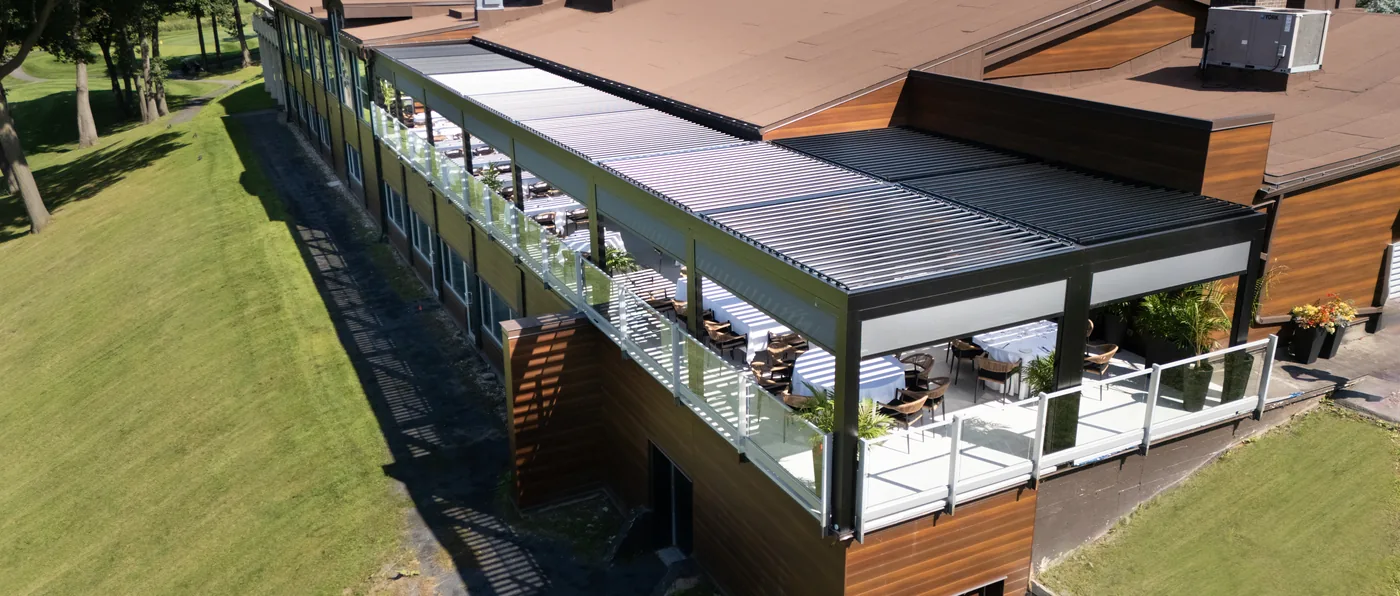 Le toit à lames vu d’en haut, le long de la terrasse, contre le toit du pavillon