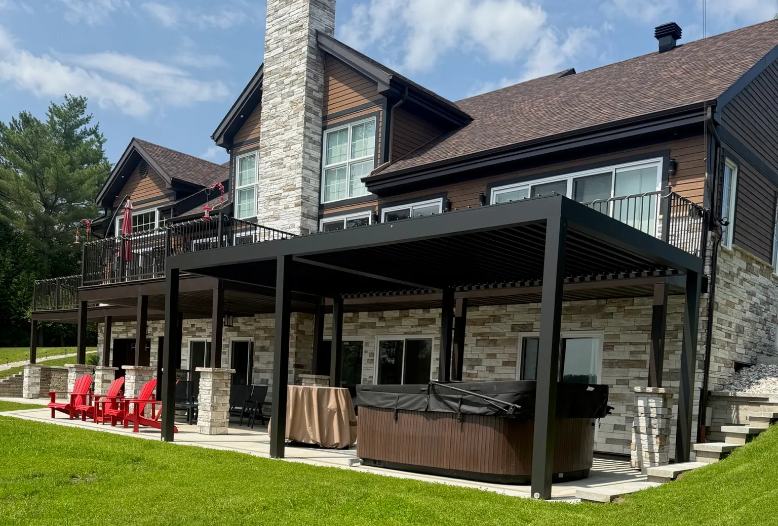 The louvred-roof pergola under the upstairs balcony, with the swim spa set underneath on the slab